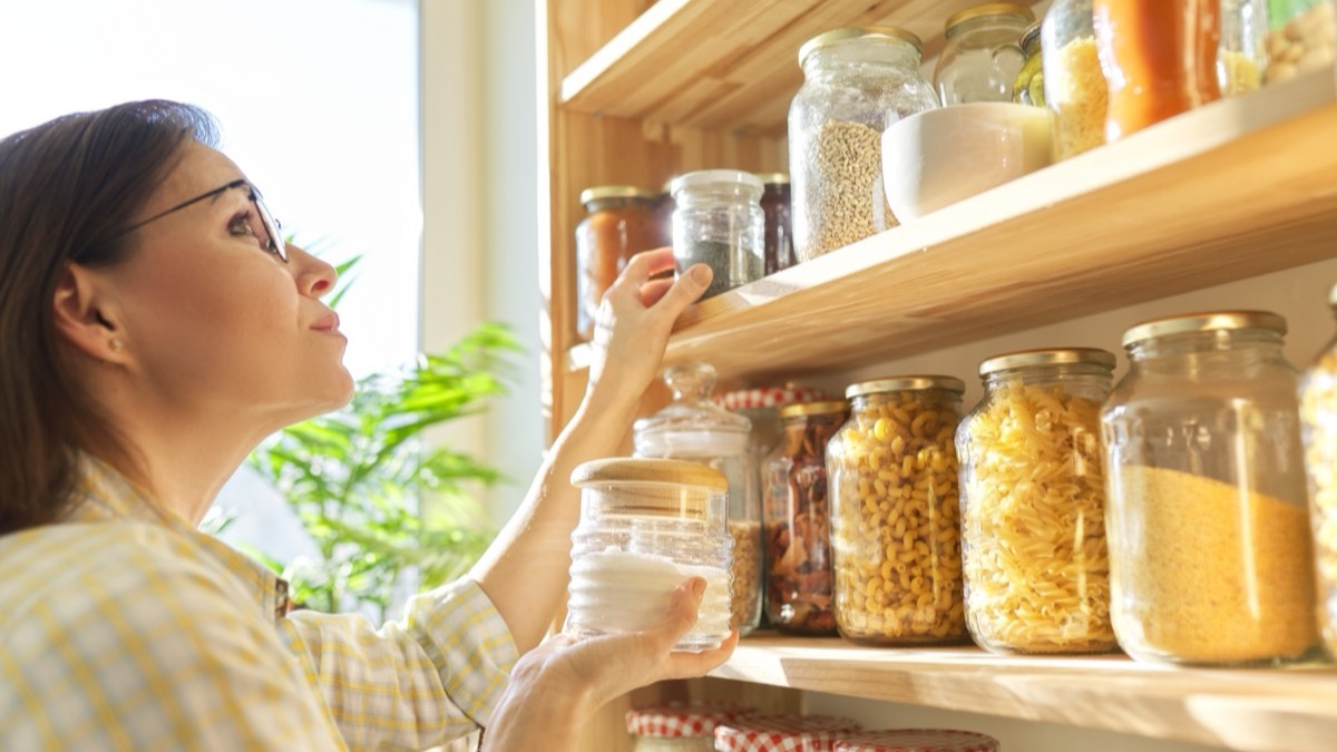 Labelled storage jars on shelves in a dry store